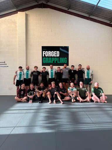 Members posing together after a session at Forged Grappling