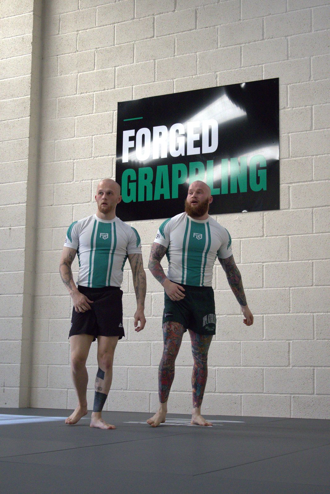 Two members walking across the mats at Forged Grappling