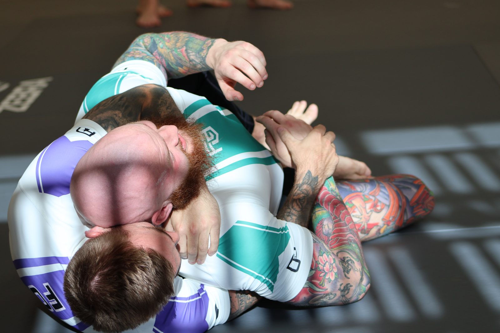 Two members battling for a submission on the mats at Forged Grappling