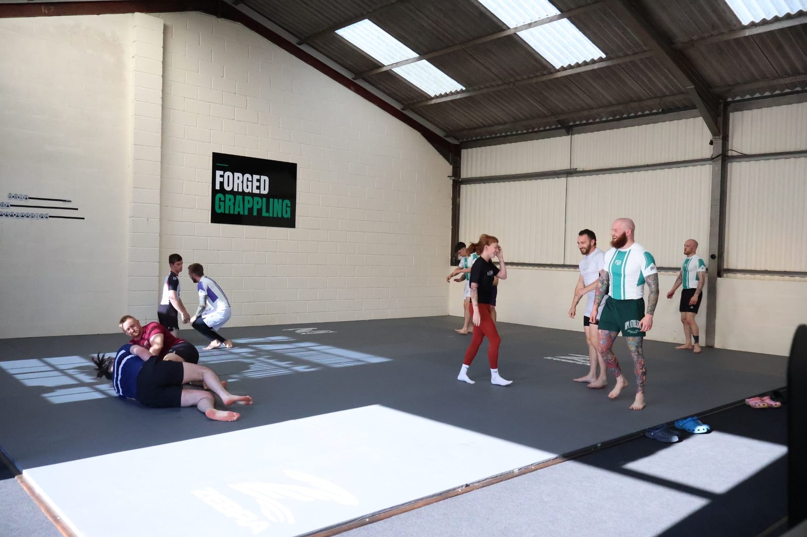 Members training across the mats during a session at Forged Grappling
