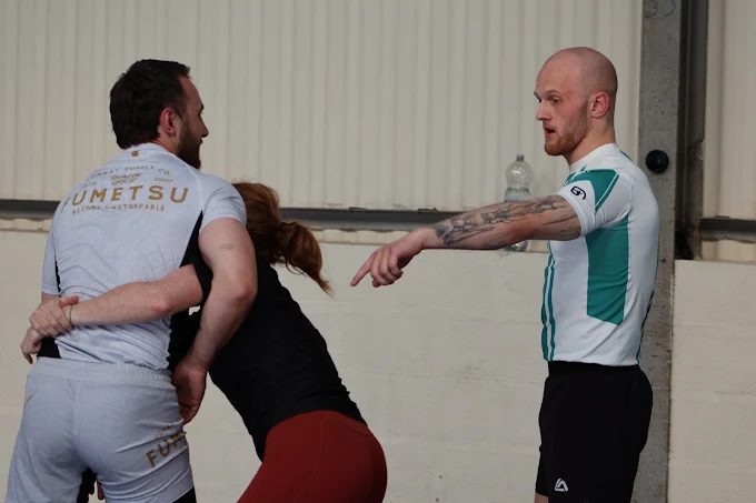A coach giving pointers to members during class at Forged Grappling