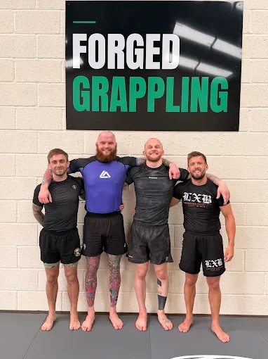 A group of members posing together at Forged Grappling