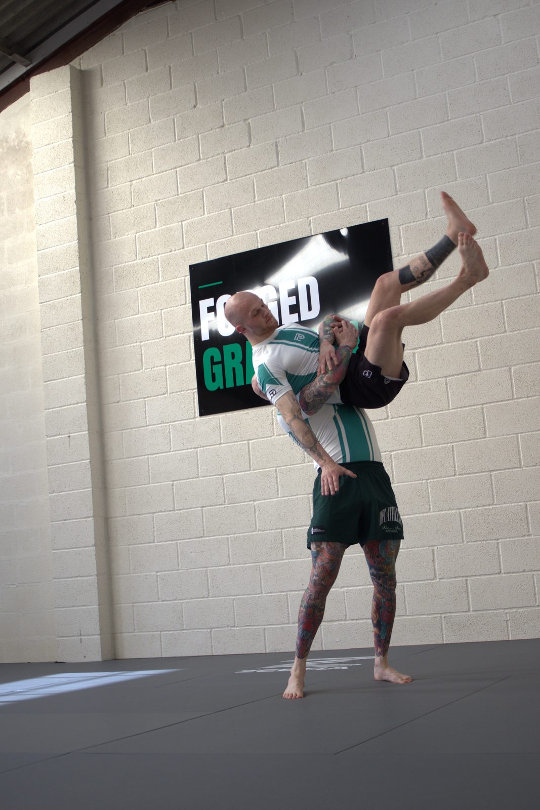 A member lifting his training partner during a no-gi grappling session