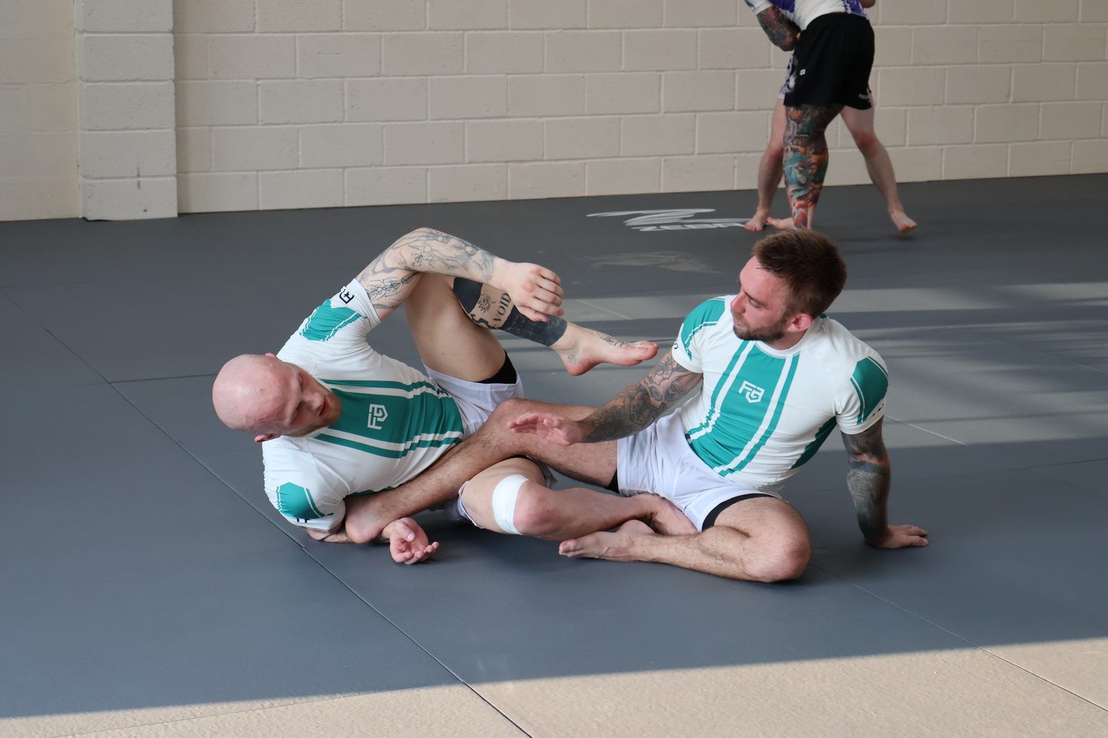 Two members scrambling for position during a no-gi grappling session at Forged Grappling